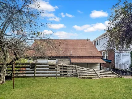 a backyard of a house with table and chairs