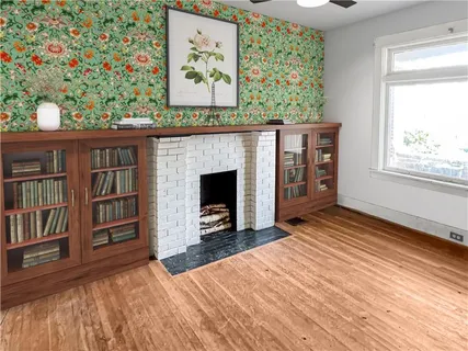 a view of an empty room with furniture and window
