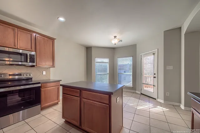 a kitchen with stainless steel appliances granite countertop a stove and a sink