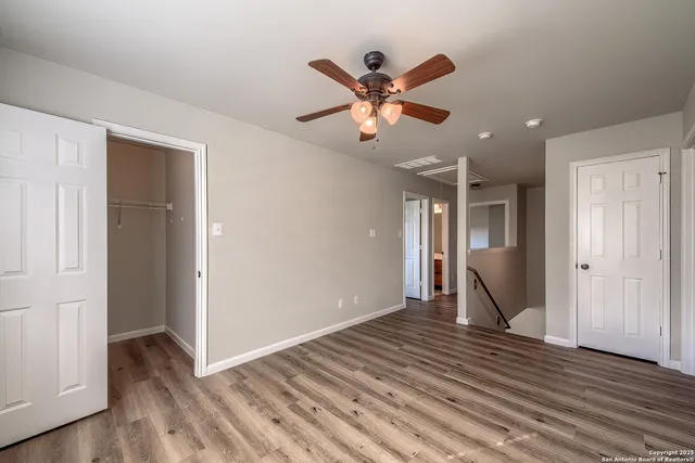 a view of an empty room and wooden floor