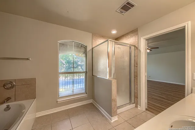 a bathroom with a bathtub and a shower