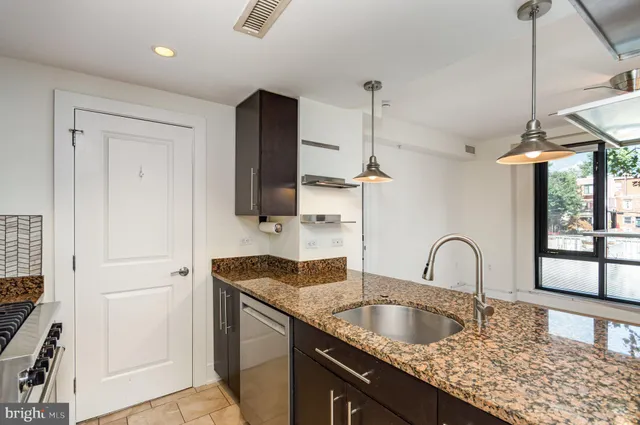 a kitchen with granite countertop a sink and a window