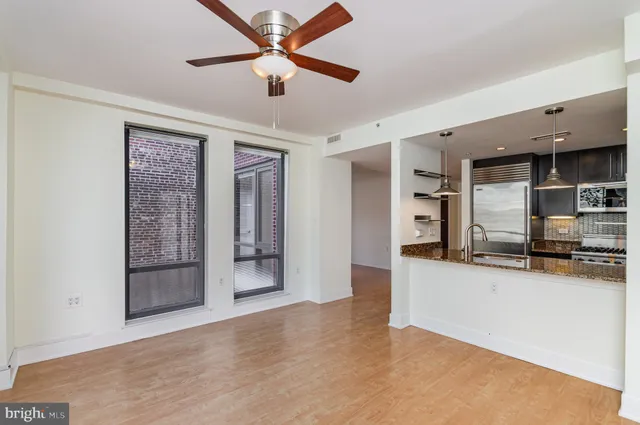 a view of a kitchen with a sink and a refrigerator