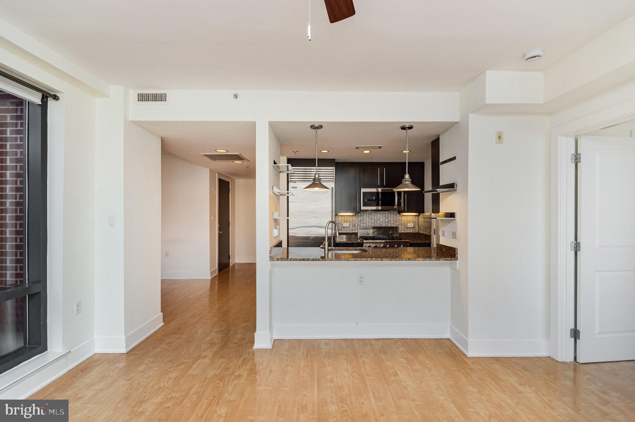 1450 Church Street Northwest, Unit 203 Washington, DC 20005 - Photo 10 of 35 a view of living room with stainless steel appliances wooden floor and view living room