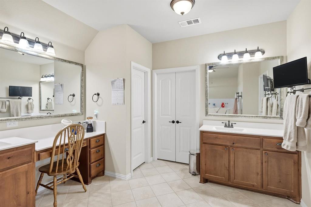 142 High Ridge Court Decatur, TX 76234 - Photo 17 of 40 a spacious bathroom with a double vanity sink and a mirror