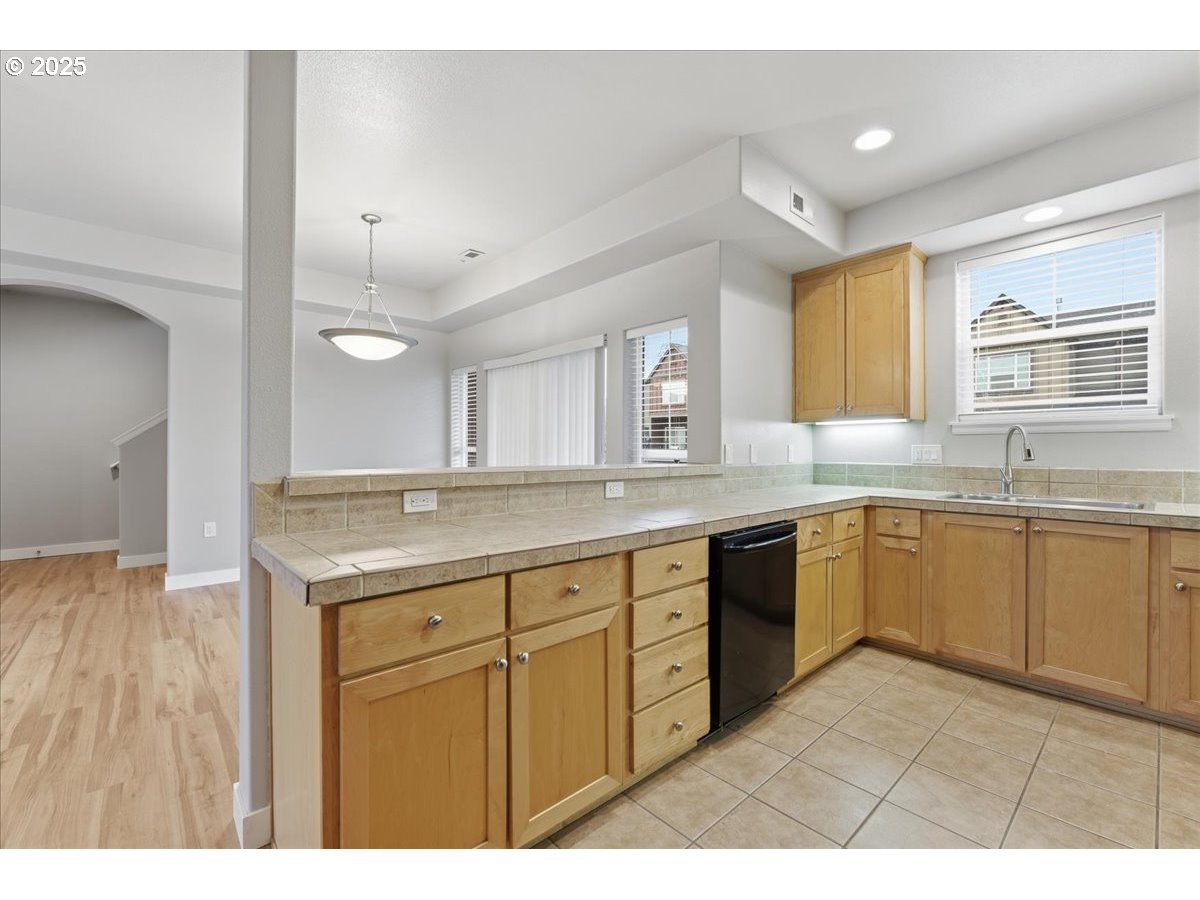 10835 Southwest Huntington Avenue Portland, OR 97223 - Photo 14 of 40 a large kitchen with a sink and cabinets