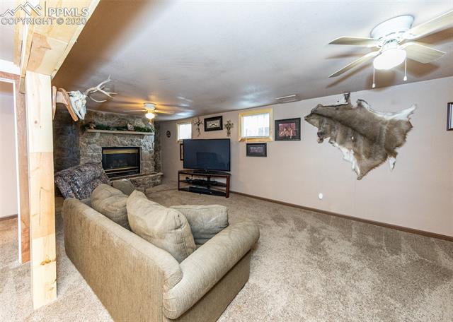 6727 Seneca Road Colorado Springs, CO 80915 - Photo 25 of 50 Large family room in basement with fireplace!
