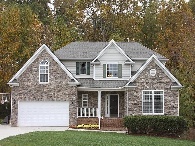 164 Mickleson Ridge Drive Raleigh, NC 27603 - Photo 1 of 25 a front view of a house with a yard and garage