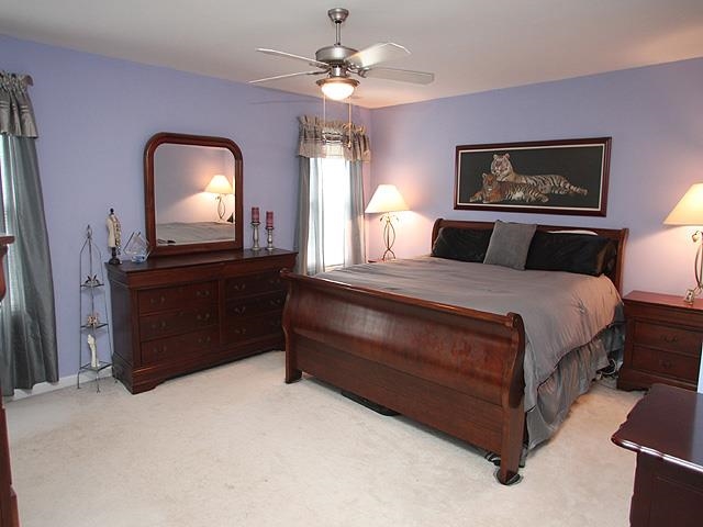 164 Mickleson Ridge Drive Raleigh, NC 27603 - Photo 13 of 25 a bedroom with a bed mirror on desk and a window