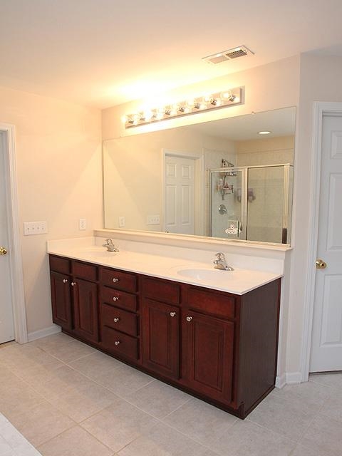 164 Mickleson Ridge Drive Raleigh, NC 27603 - Photo 14 of 25 a bathroom with a double vanity sink and a mirror