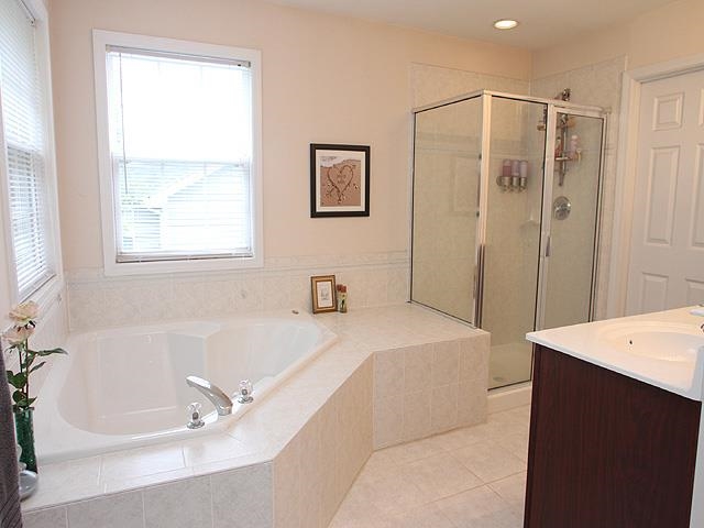 164 Mickleson Ridge Drive Raleigh, NC 27603 - Photo 15 of 25 a spacious bathroom with a tub sink and mirror