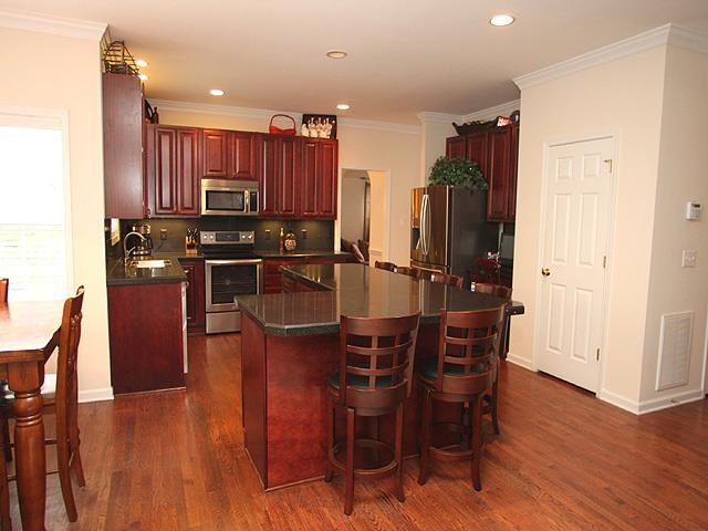 164 Mickleson Ridge Drive Raleigh, NC 27603 - Photo 5 of 25 a kitchen with stainless steel appliances a dining table chairs and wooden floor