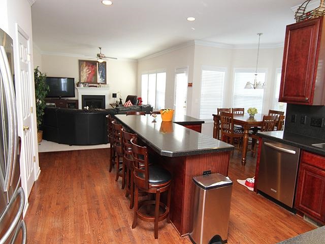 164 Mickleson Ridge Drive Raleigh, NC 27603 - Photo 8 of 25 a kitchen with granite countertop a table chairs stove and refrigerator