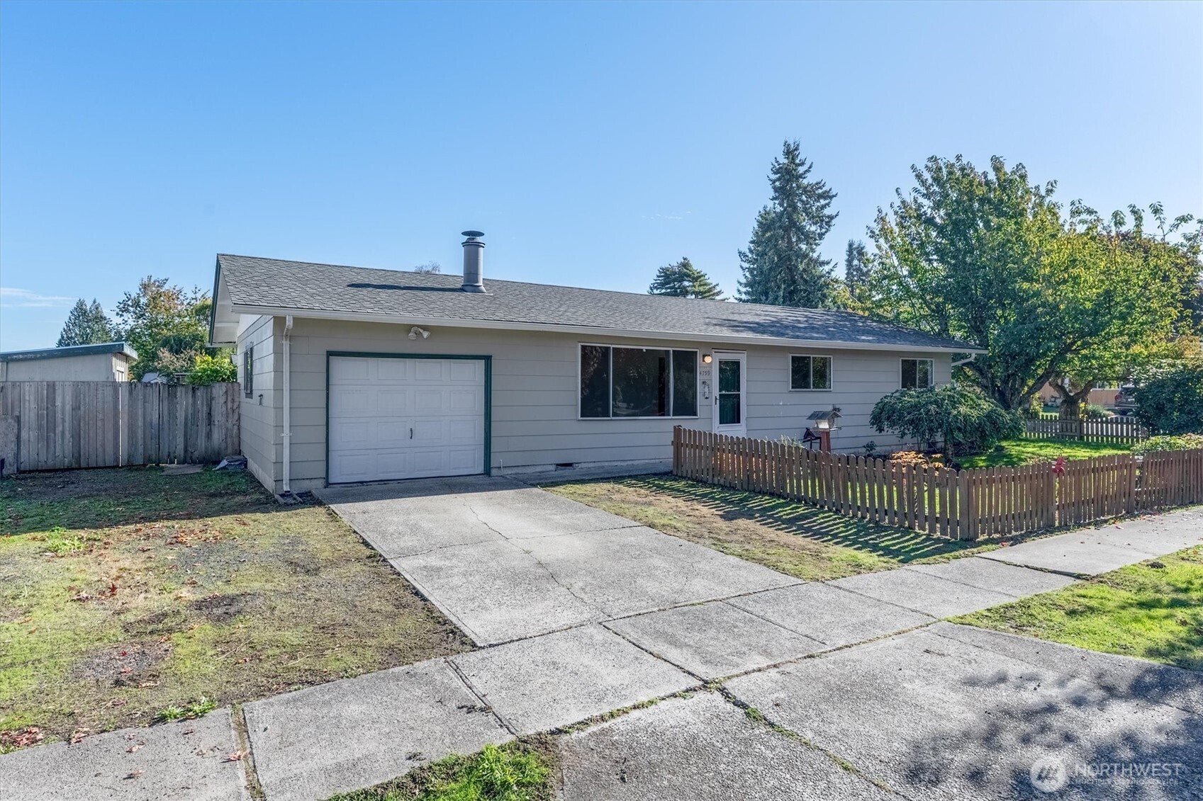 4759 Windemere Street Longview, WA 98632 - Photo 26 of 38 a front view of a house with a yard and garage