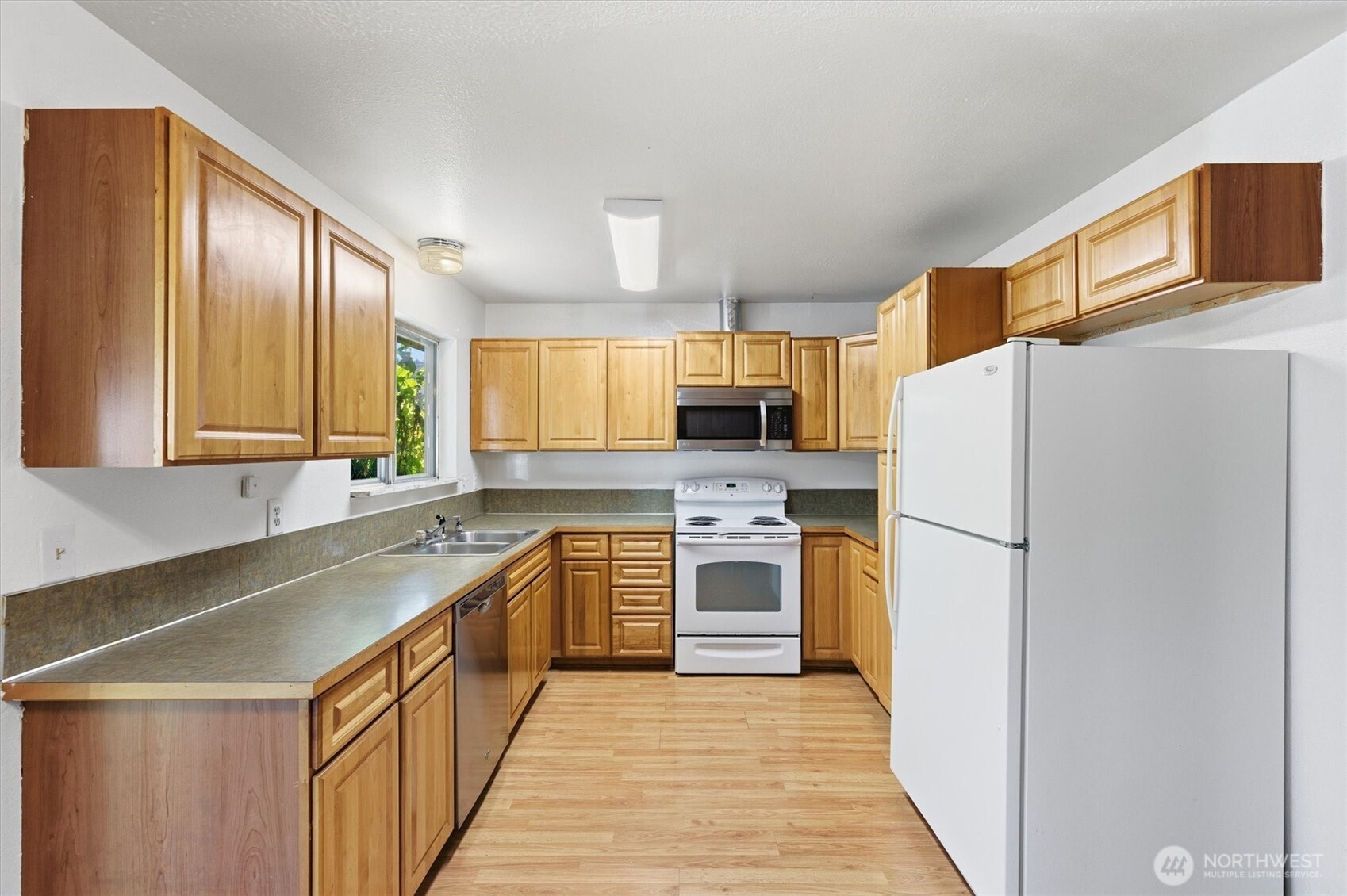 4759 Windemere Street Longview, WA 98632 - Photo 3 of 38 a kitchen with a refrigerator a stove top oven a sink and dishwasher