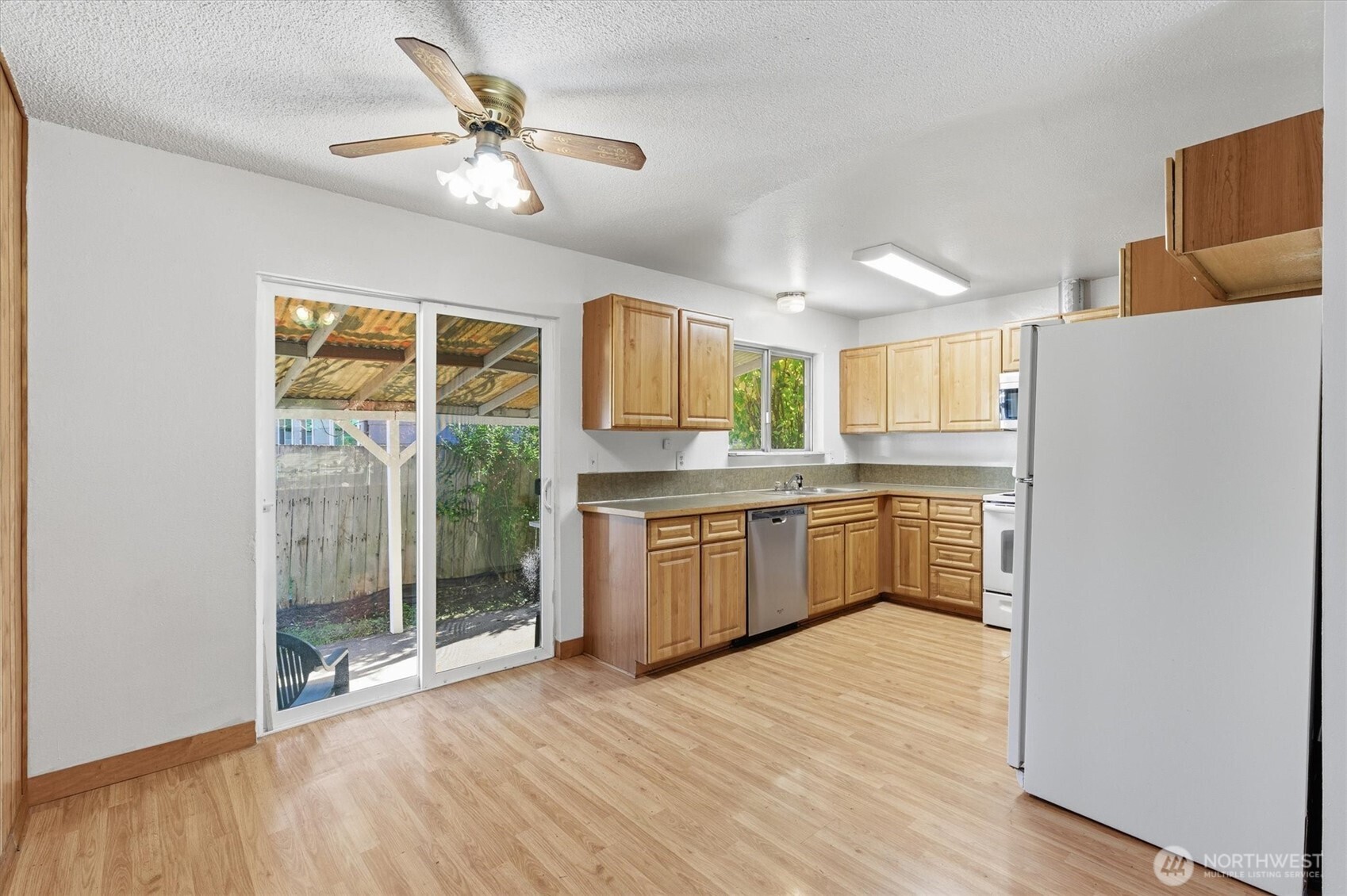 4759 Windemere Street Longview, WA 98632 - Photo 4 of 38 a kitchen with stainless steel appliances granite countertop a refrigerator a sink dishwasher a stove with wooden floor and dining table