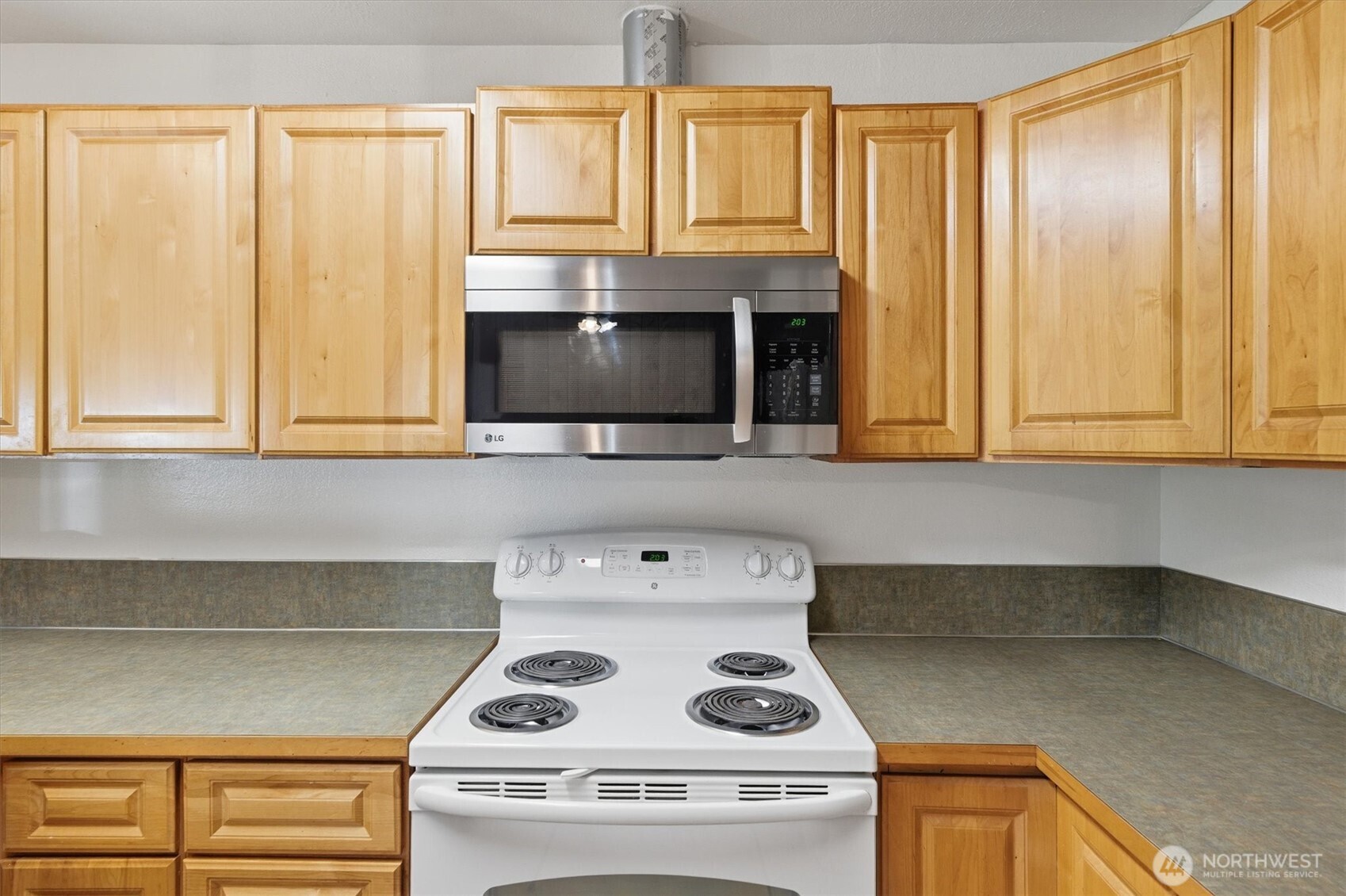 4759 Windemere Street Longview, WA 98632 - Photo 7 of 38 a kitchen with a stove and a microwave