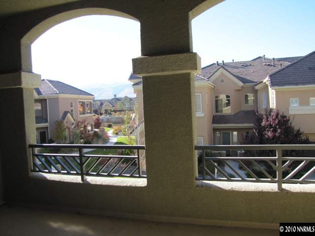 9900 Wilbur May Parkway, Unit 3405 Reno, NV 89521 - Photo 9 of 12 a view of balcony with two chairs and a fire pit