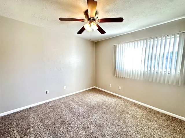 a view of room with window and ceiling fan