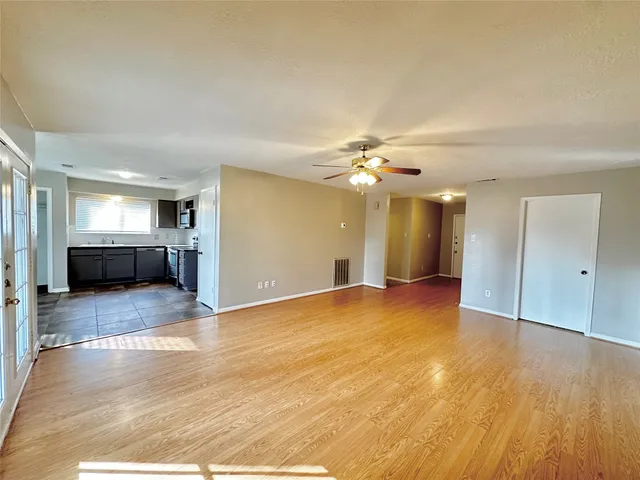 a view of a livingroom with a kitchen counter tops and empty room