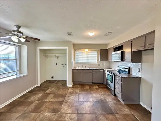 a large kitchen with a large window