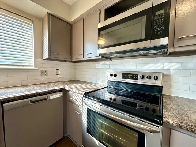 a kitchen with a stove and a microwave