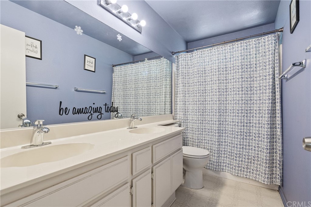 782 De La Luz Circle Perris, CA 92571 - Photo 25 of 25 a bathroom with a sink a toilet and shower