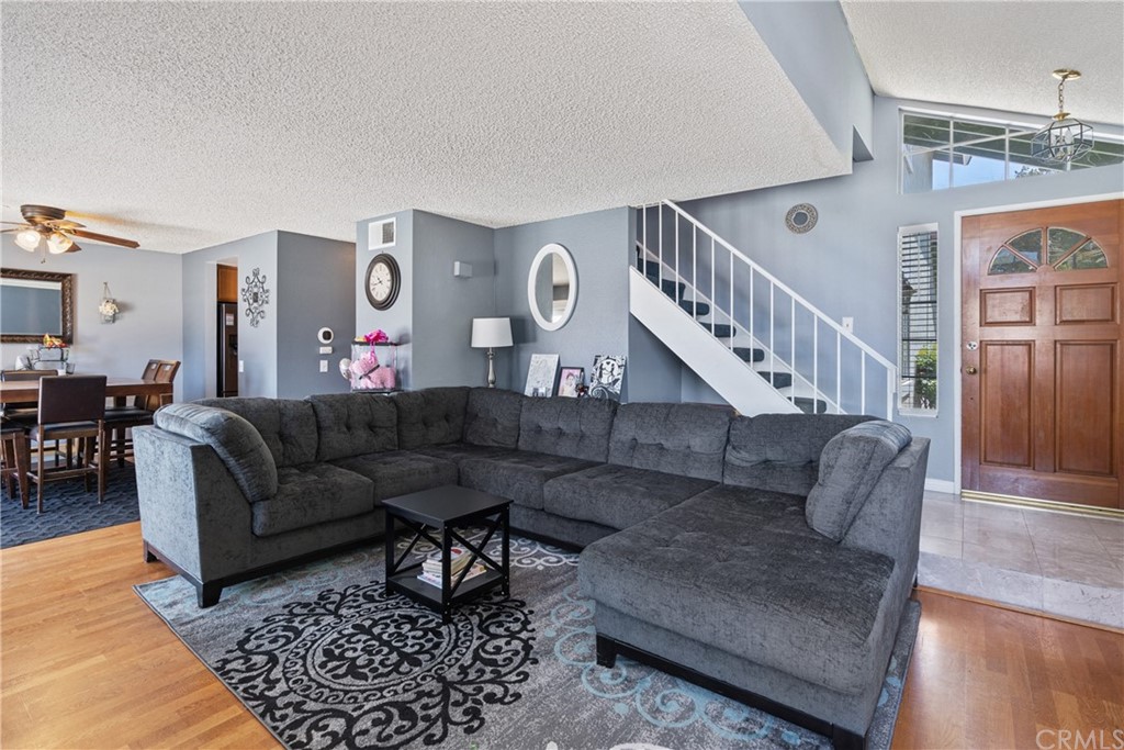 782 De La Luz Circle Perris, CA 92571 - Photo 6 of 25 a living room with furniture and a chandelier
