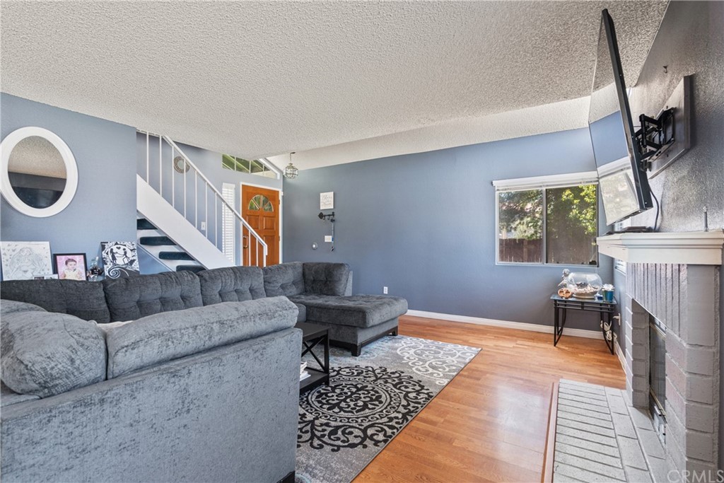 782 De La Luz Circle Perris, CA 92571 - Photo 7 of 25 a living room with furniture and a fireplace