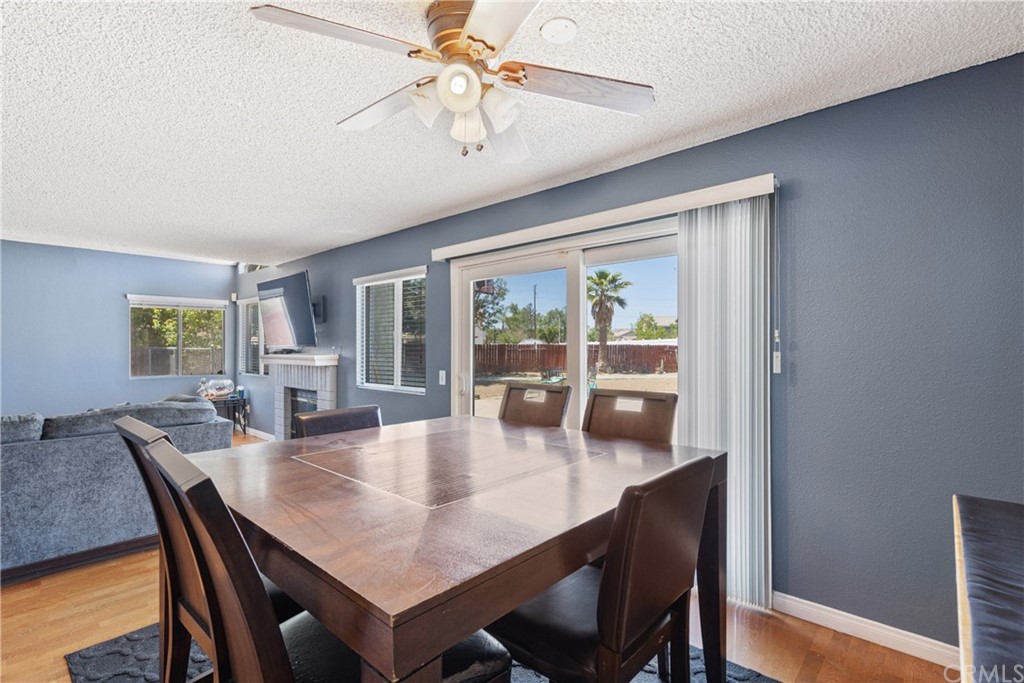 782 De La Luz Circle Perris, CA 92571 - Photo 9 of 25 a dining room with furniture a chandelier and wooden floor