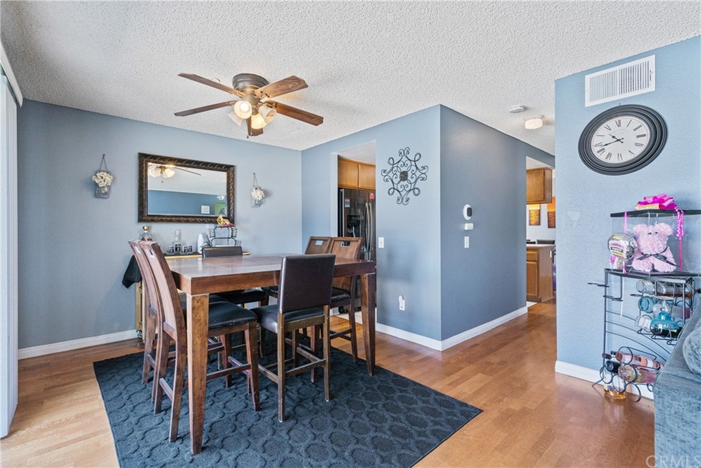 782 De La Luz Circle Perris, CA 92571 - Photo 10 of 25 a view of a dining room with furniture and wooden floor