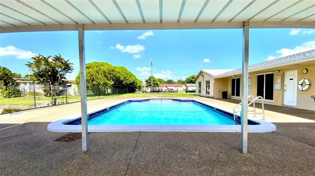 a room with pool table and chairs