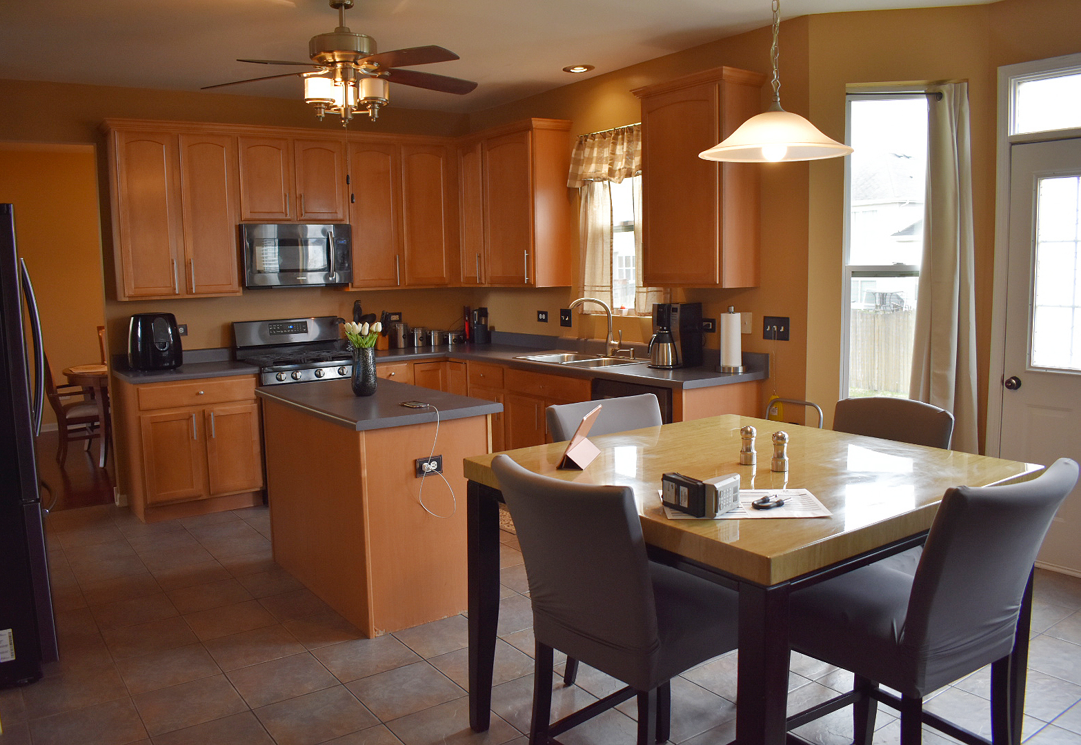 1923 Brimstone Road Romeoville, IL 60446 - Photo 4 of 14 a dining room with a table chairs and a kitchen view