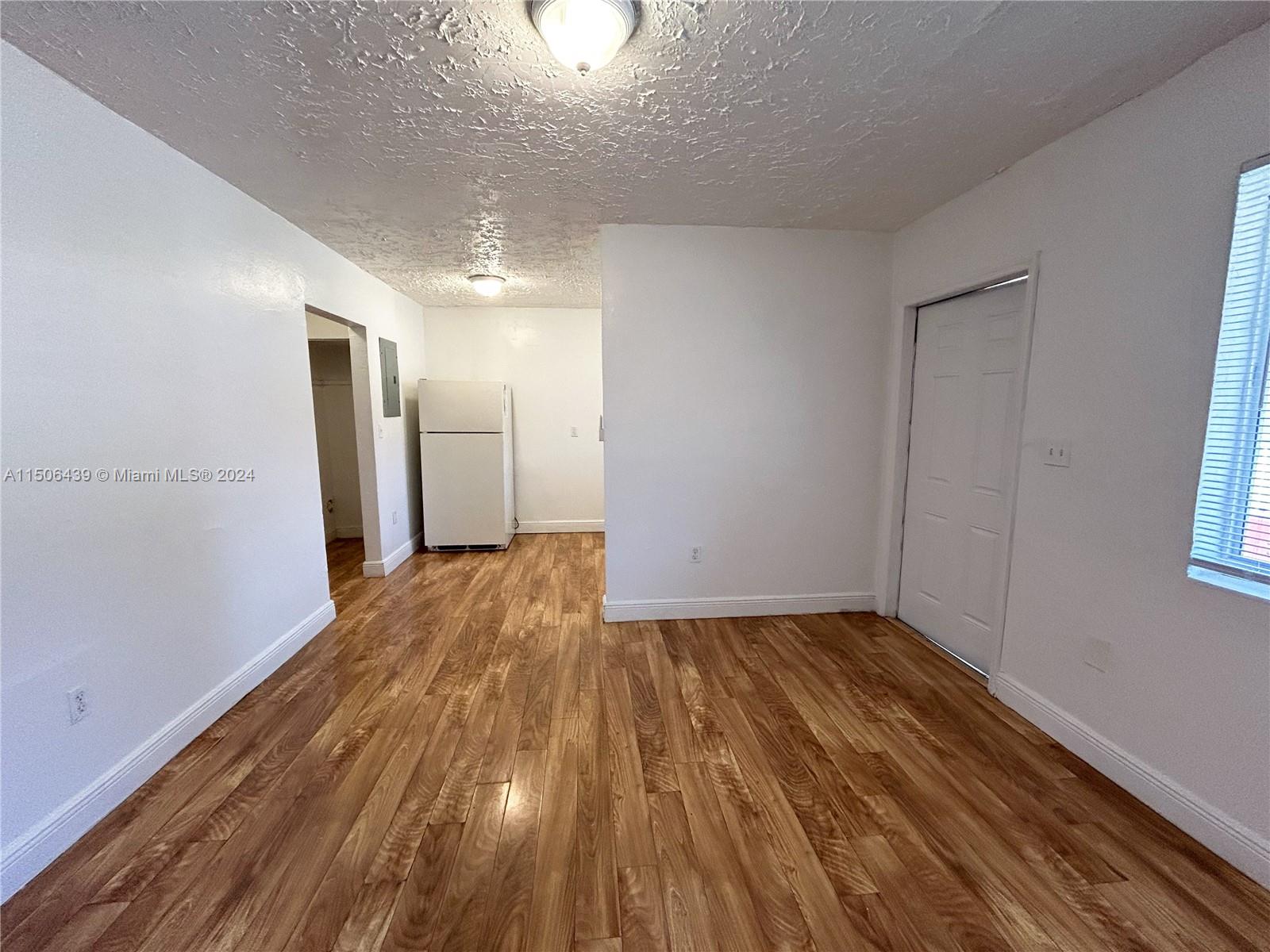 641 Northeast 86th Street, Unit 3 Miami, FL 33138 - Photo 4 of 10 a view of a room with wooden floor