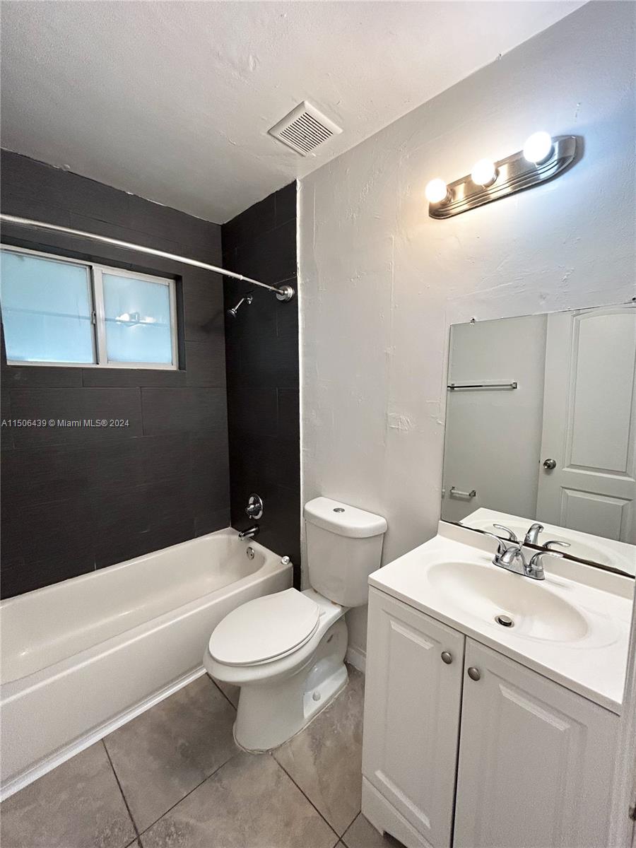 641 Northeast 86th Street, Unit 3 Miami, FL 33138 - Photo 8 of 10 a bathroom with a sink a toilet and shower