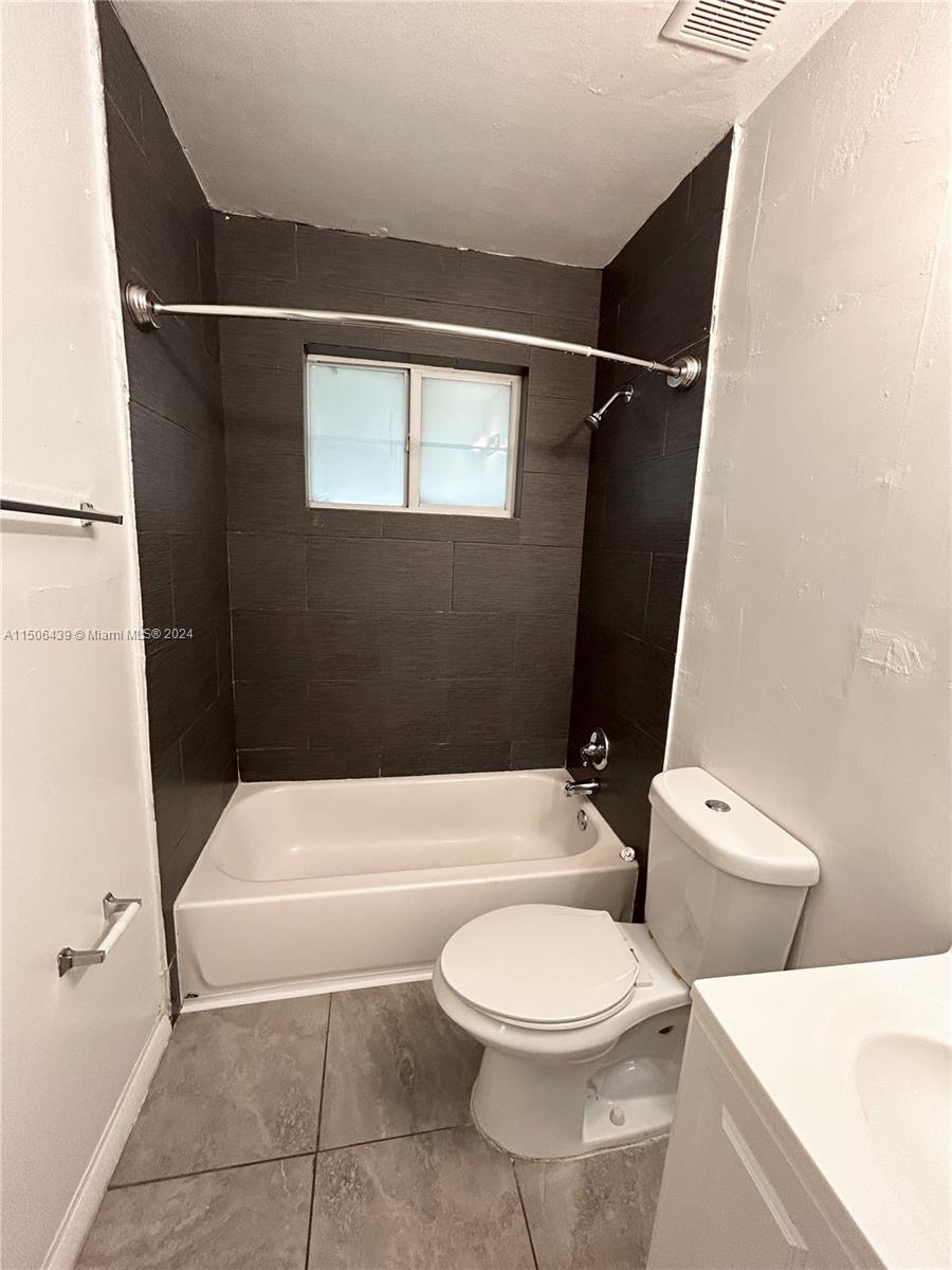 641 Northeast 86th Street, Unit 3 Miami, FL 33138 - Photo 9 of 10 a bathroom with a toilet and a shower