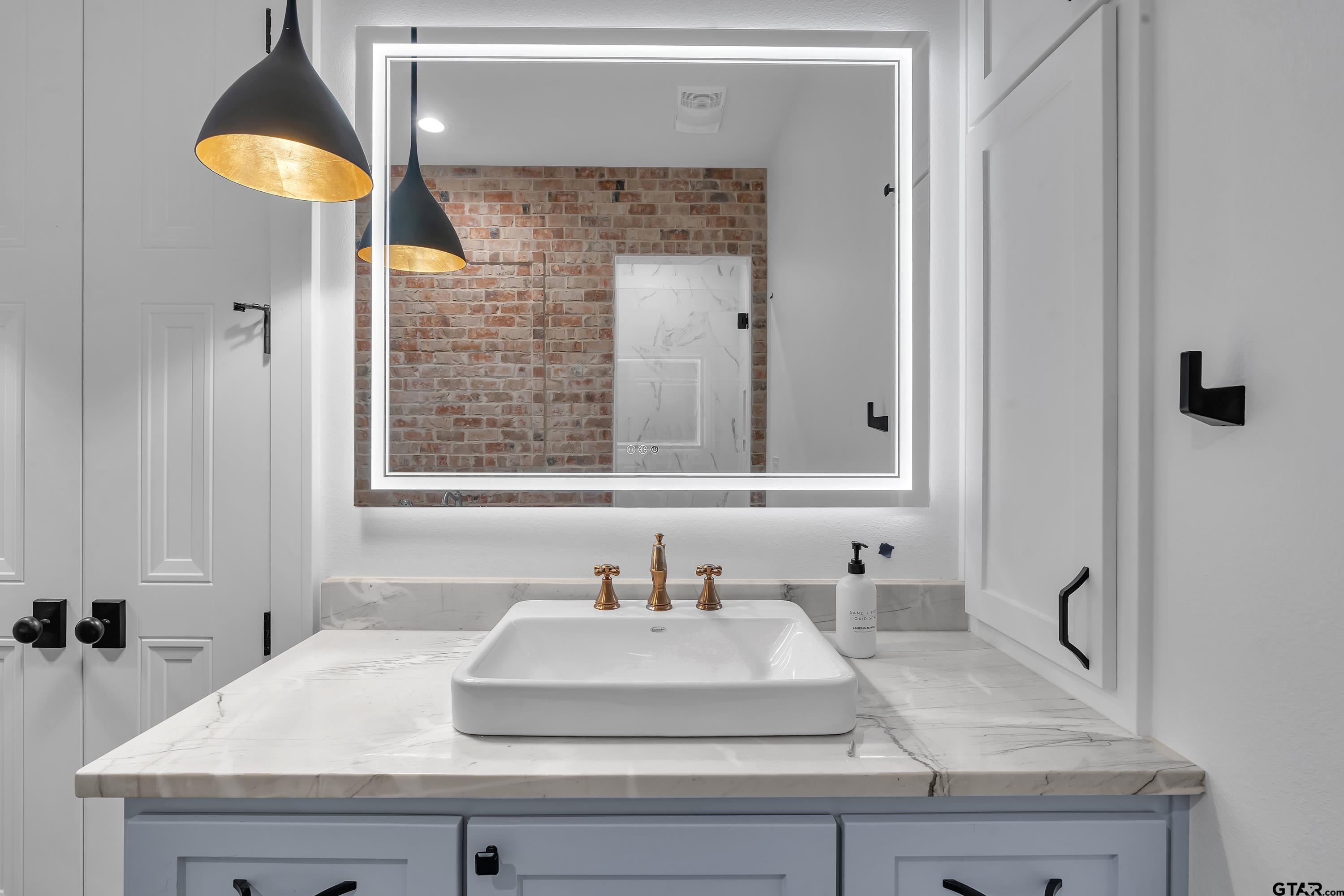 500 Roberts Circle Longview, TX 75605 - Photo 43 of 48 a bathroom with a granite countertop sink and a mirror