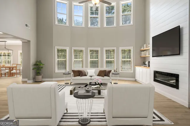 a living room with furniture a fireplace and a flat screen tv