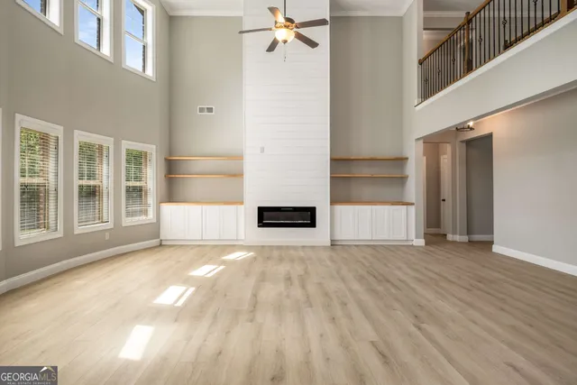 a view of a kitchen with wooden floor and a fireplace