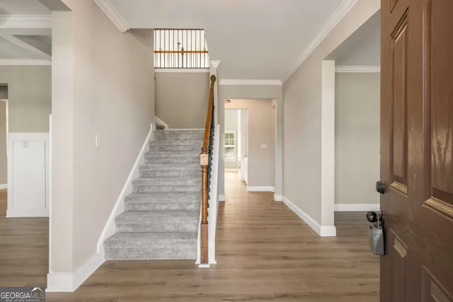 a view of a hallway with wooden floor and entryway