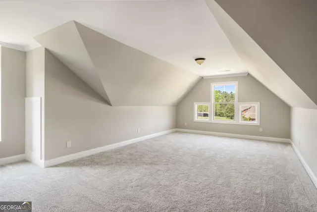 a room with furniture a flat screen tv and windows