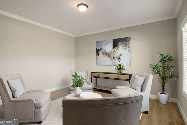 a dining room with furniture and potted plant