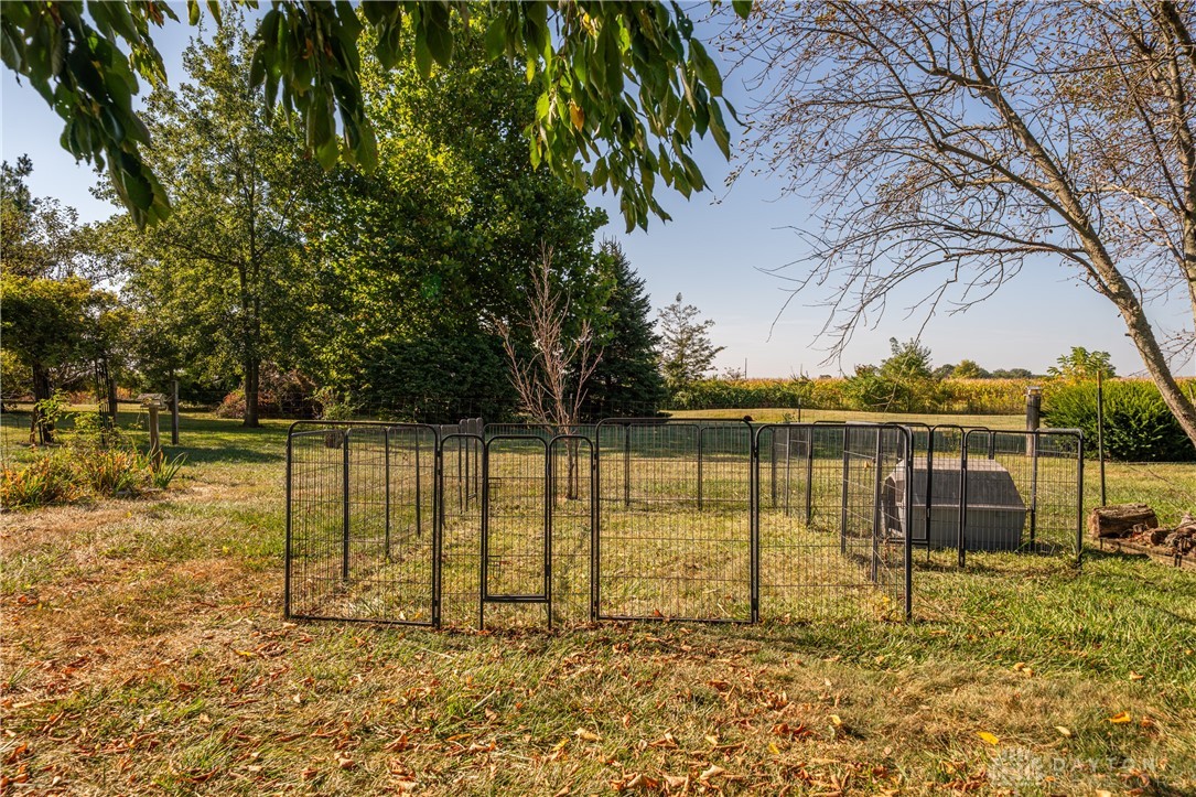 1599 Garringer Road Jamestown, OH 45335 - Photo 40 of 73 This expansive yard features a fenced area and lush greenery, ideal for outdoor activities.