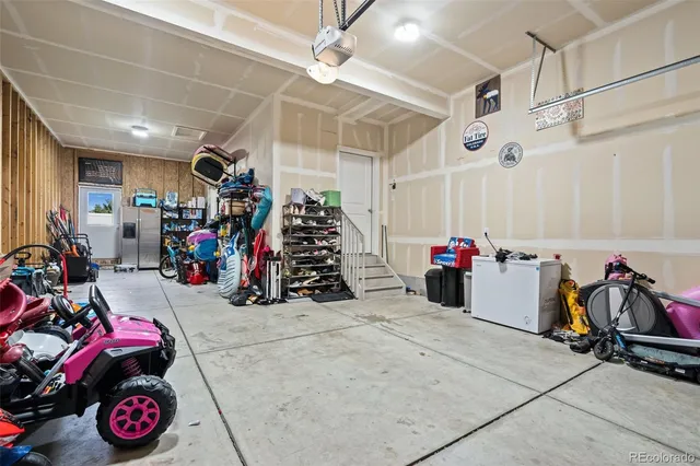 a spacious bedroom with a bed and a chandelier