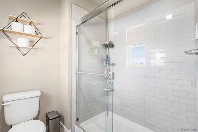 a view of walk in closet with clothes