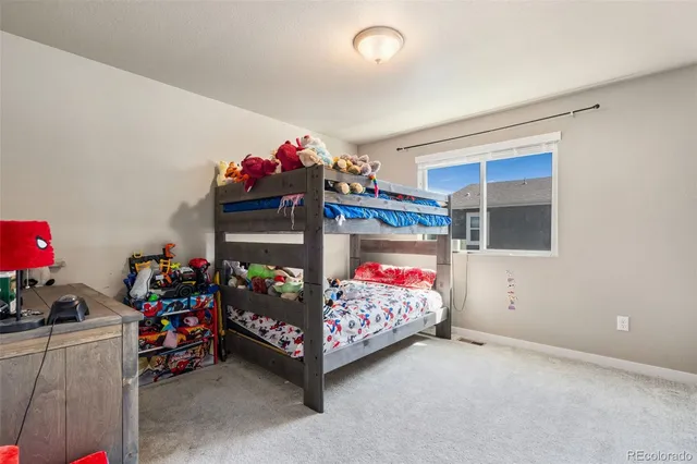 a bedroom with a bed and a tv