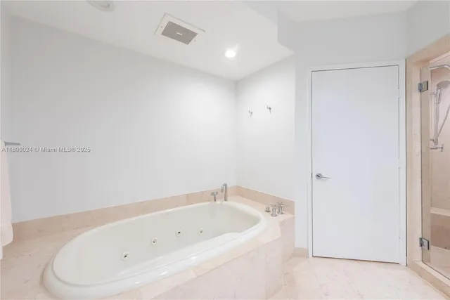 a bedroom with furniture and large window