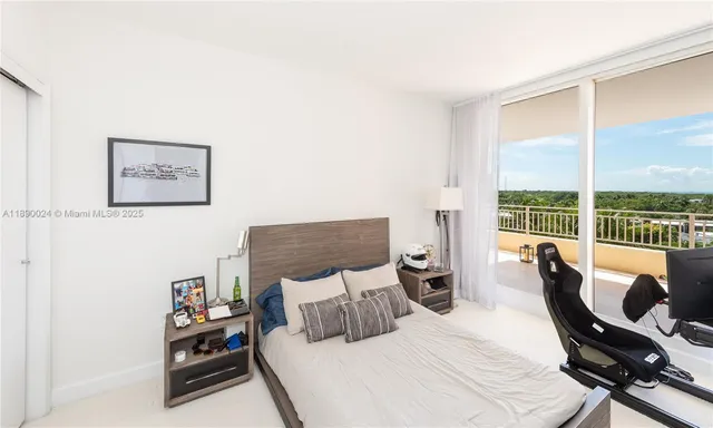 a bedroom with a large bed and a tv on table