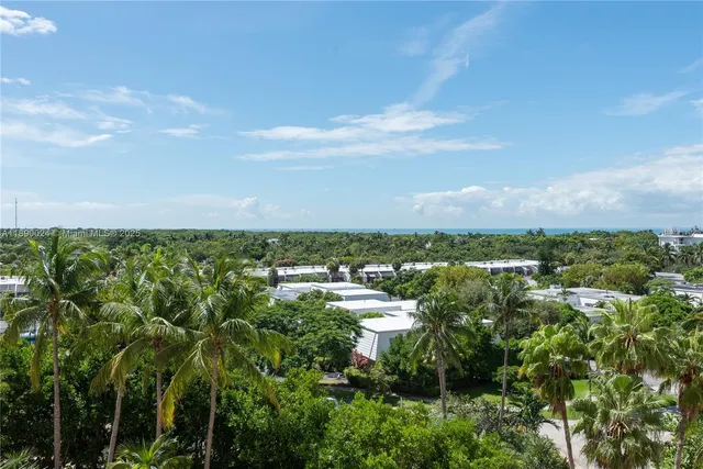 a view of a balcony with a dining table and chairs