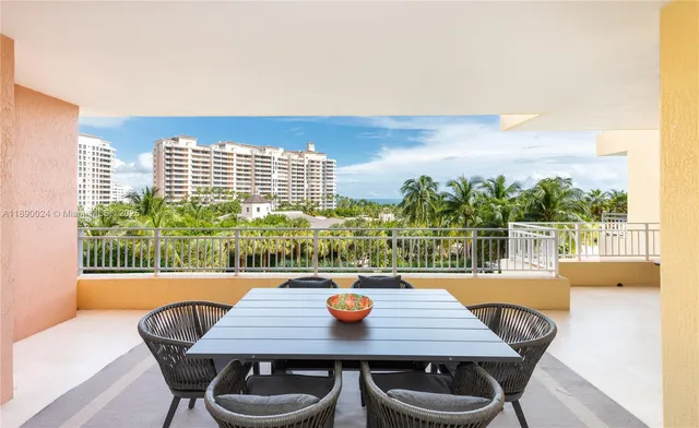 a view of a city from a dining room with furniture and window